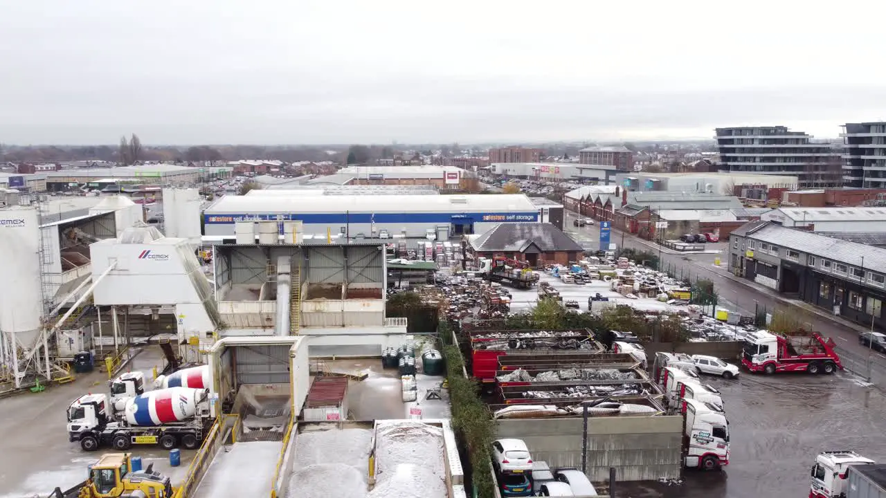 Industrial CEMEX concrete manufacturing factory yard aerial view with trucks parked around materials