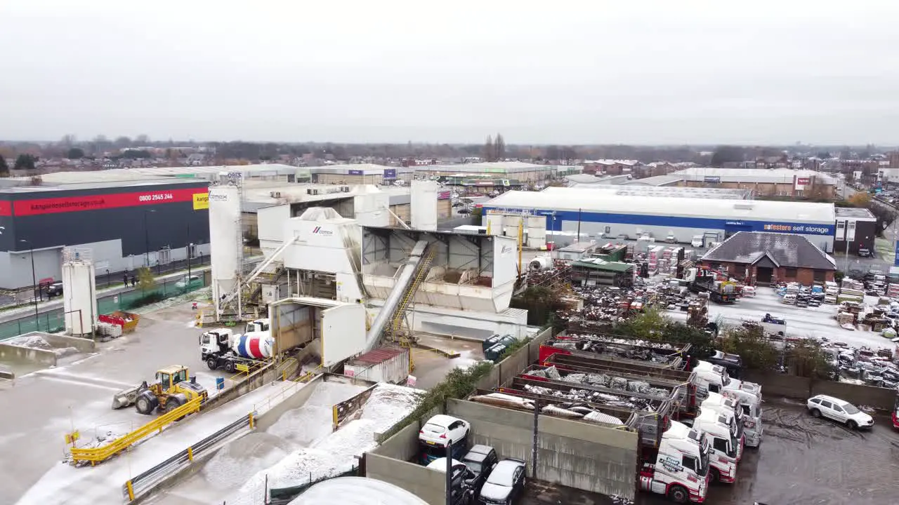 Industrial CEMEX concrete manufacturing factory yard aerial view with trucks parked around equipment