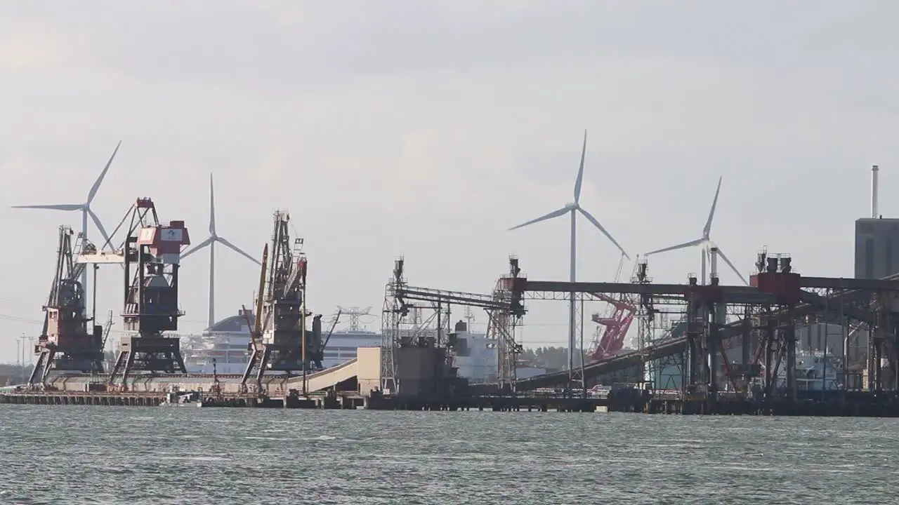 Looking across the water from the Hook of Holland towards factories and cranes etc