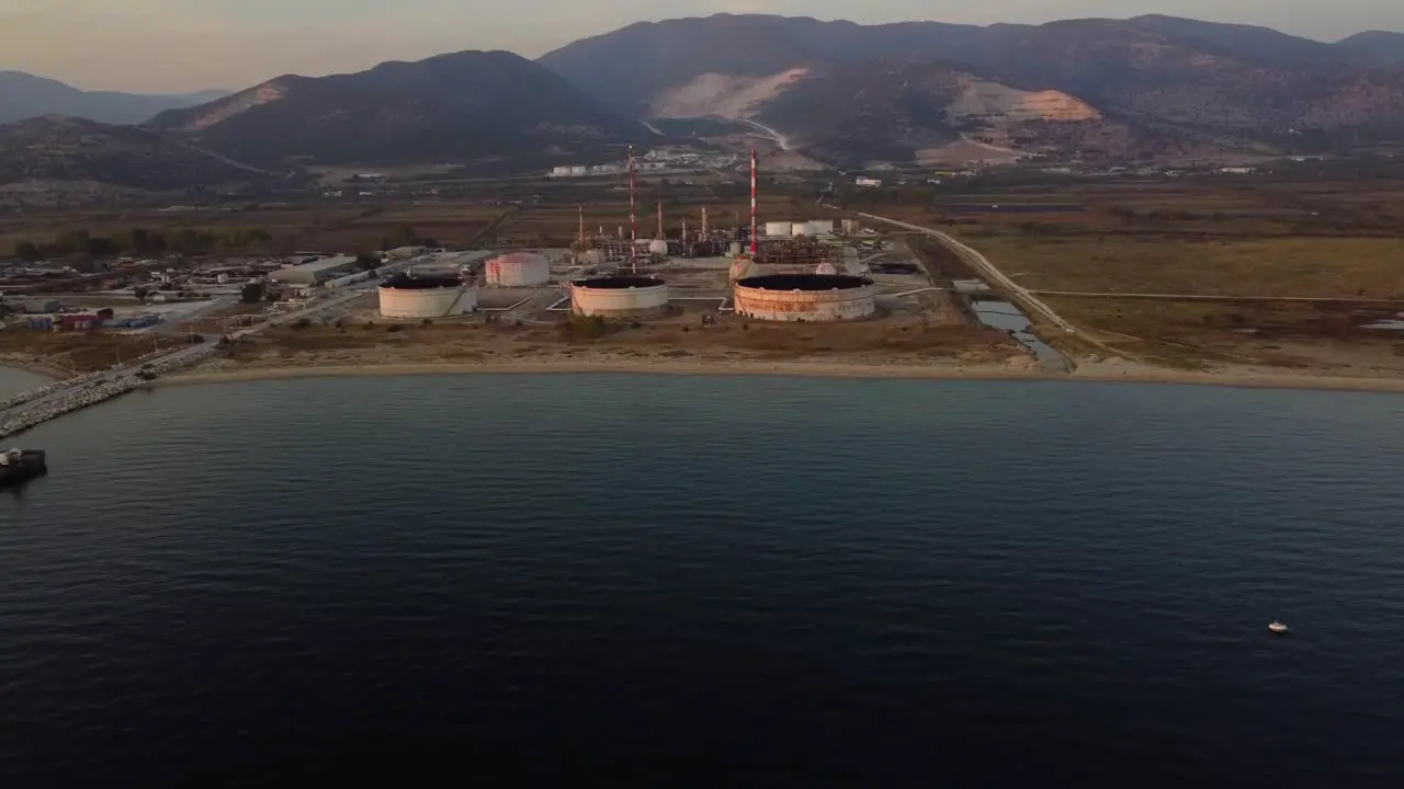 Aerial pan of oil refinery from the sea