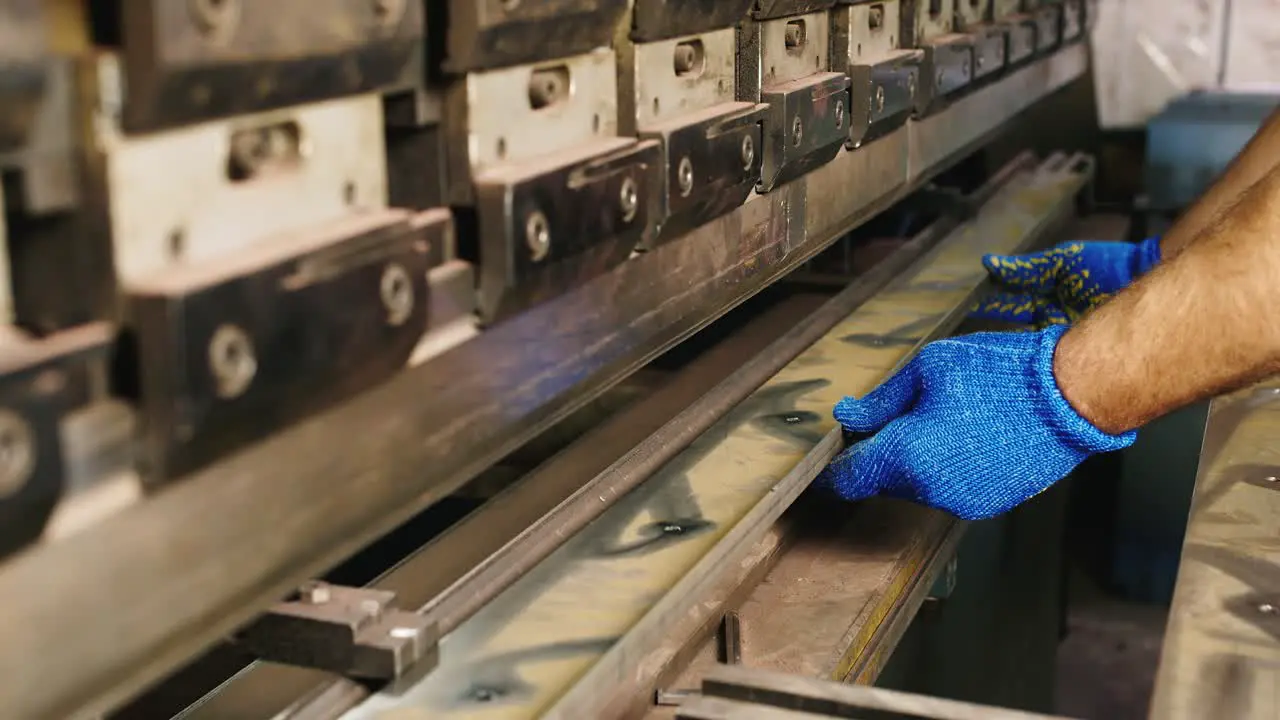 Worker puts a metal workpiece in a machine 1