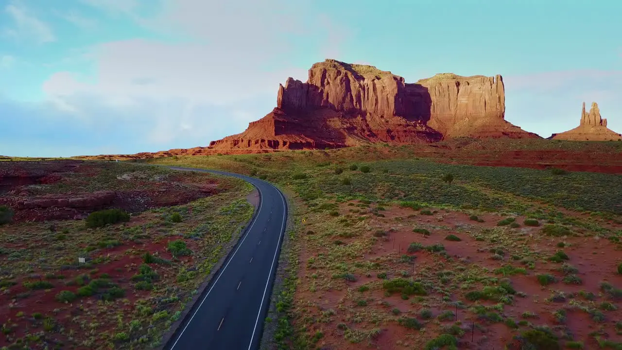 An aerial over a truck traveling on a road through Navajo country in Arizona