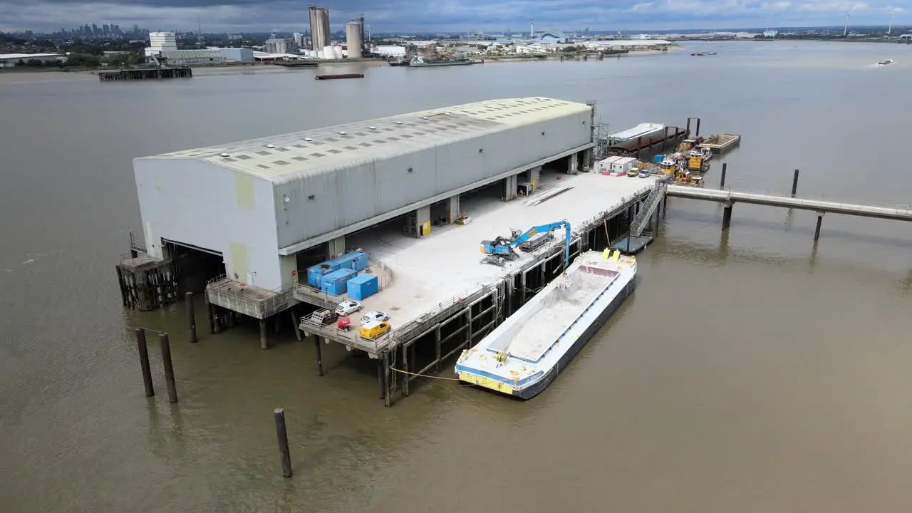 Barge Unloading at Dock on River Thames UK Essex drone footage