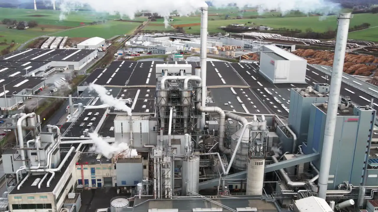 Aerial View of Polluting Wood Processing Factory in Germany Smoke from Production Process Filling the Atmosphere at Plant Manufacturing Yard