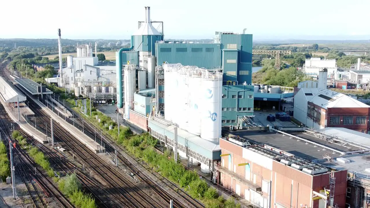 Industrial chemical manufacturing factory next to Warrington Bank Quay train tracks aerial view