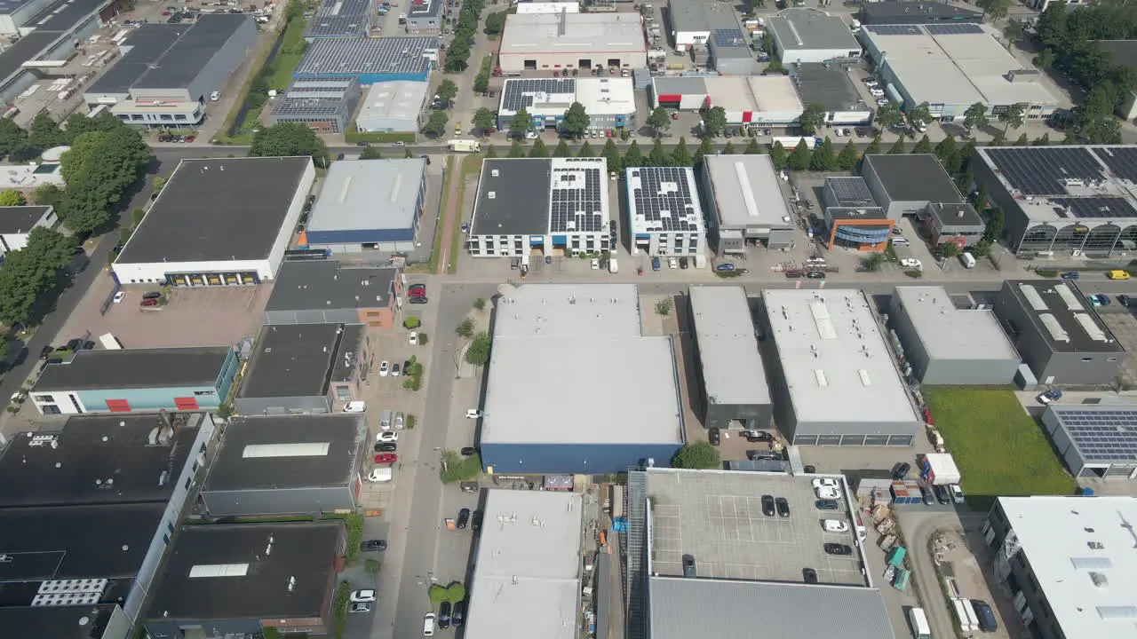 aerial view of multiple buildings with photovoltaic solar panels on rooftop on industrial terrain