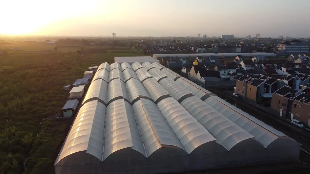 Drone flying above greenhouse organic plantation next to