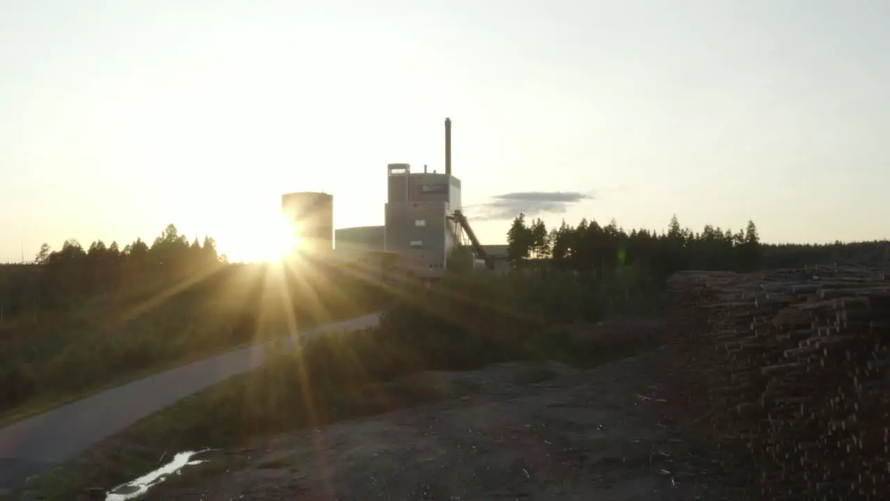 4k Aerial view over a timber wood factory in Sweden during sunset