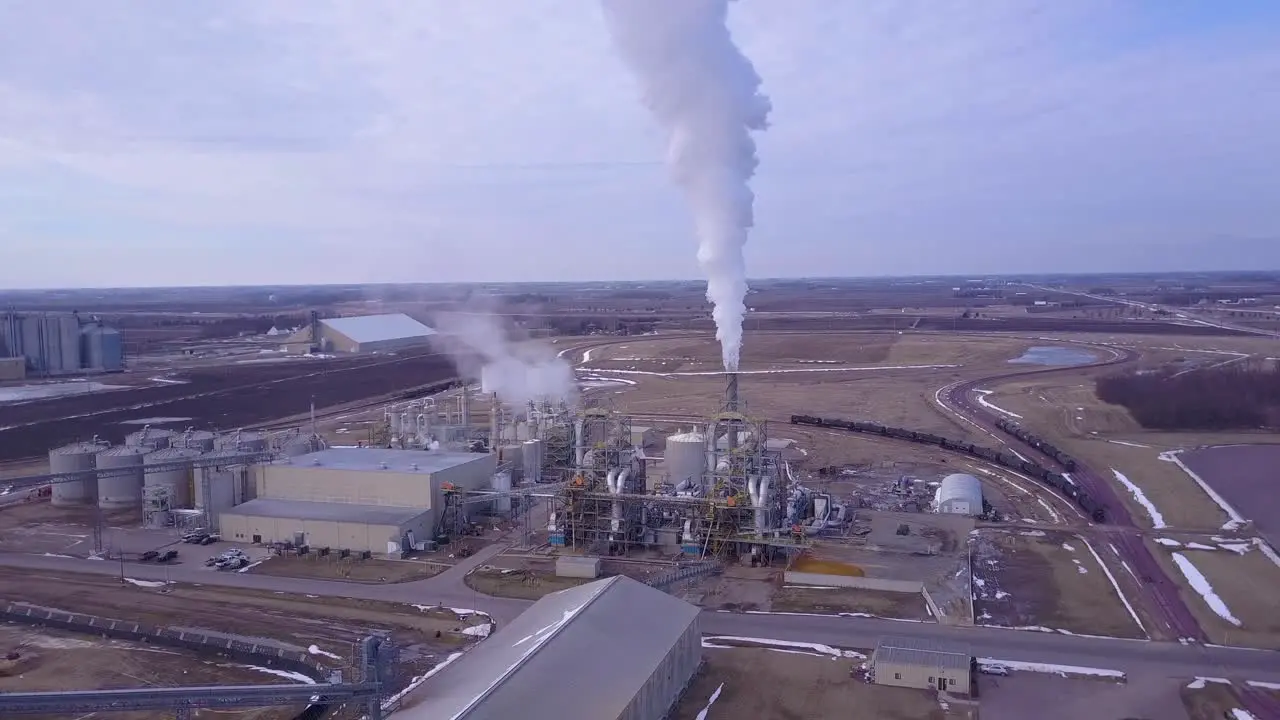 An aerial shot over an oil refinery spewing pollution into the air