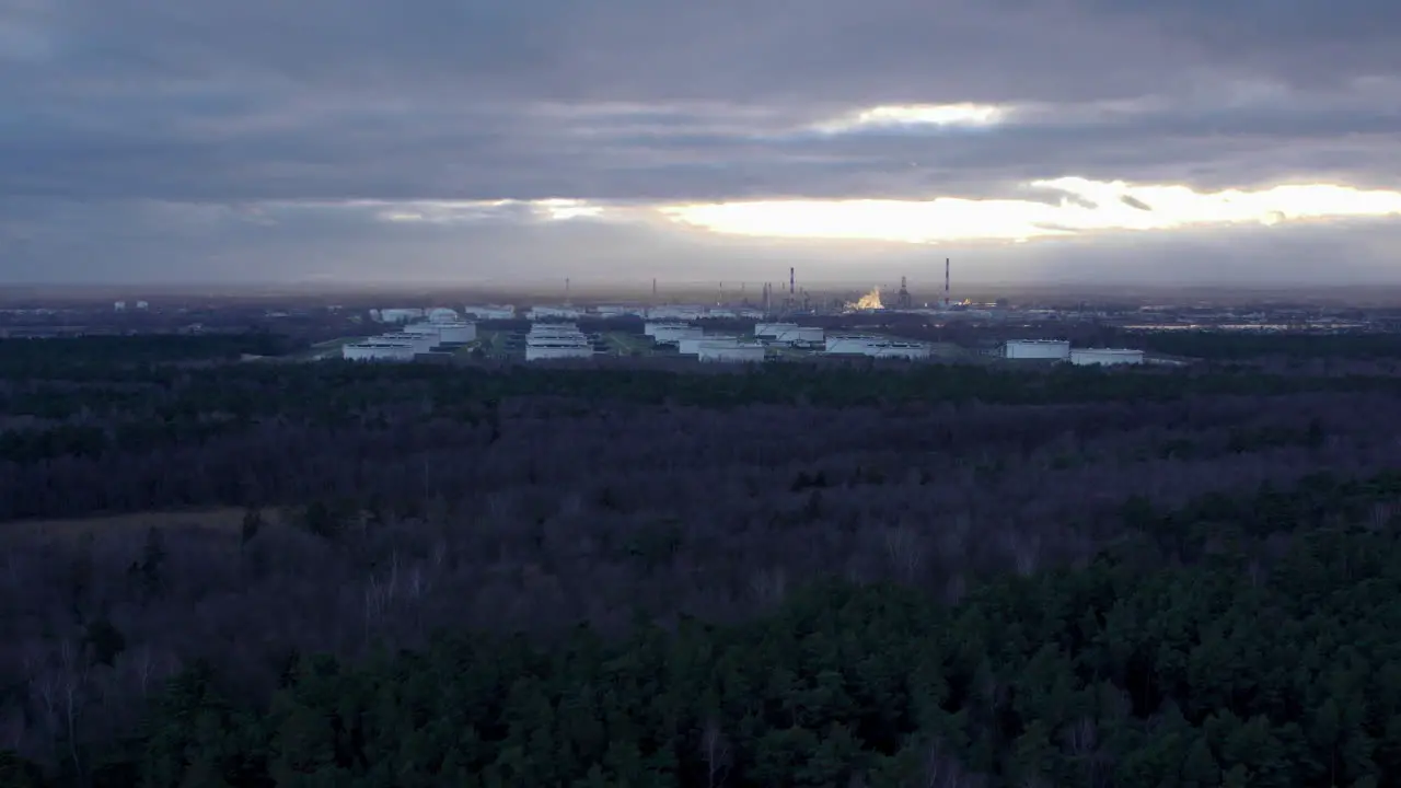 Aerial flight towards Pern Factory in Gdansk with liquids storage terminal during cloudy day