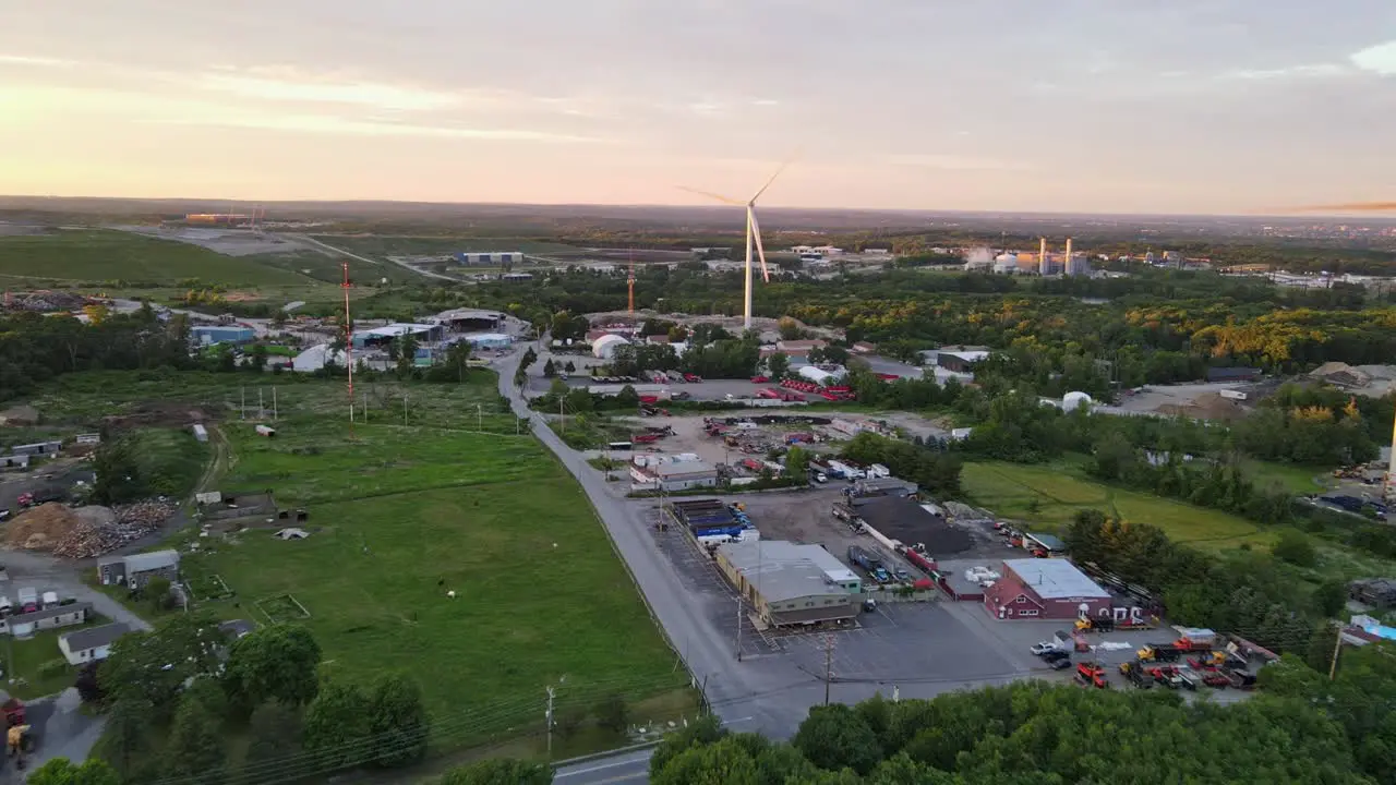 Aerial shot of windmills generating electricity in Rhode Island working into the night generating clean energy