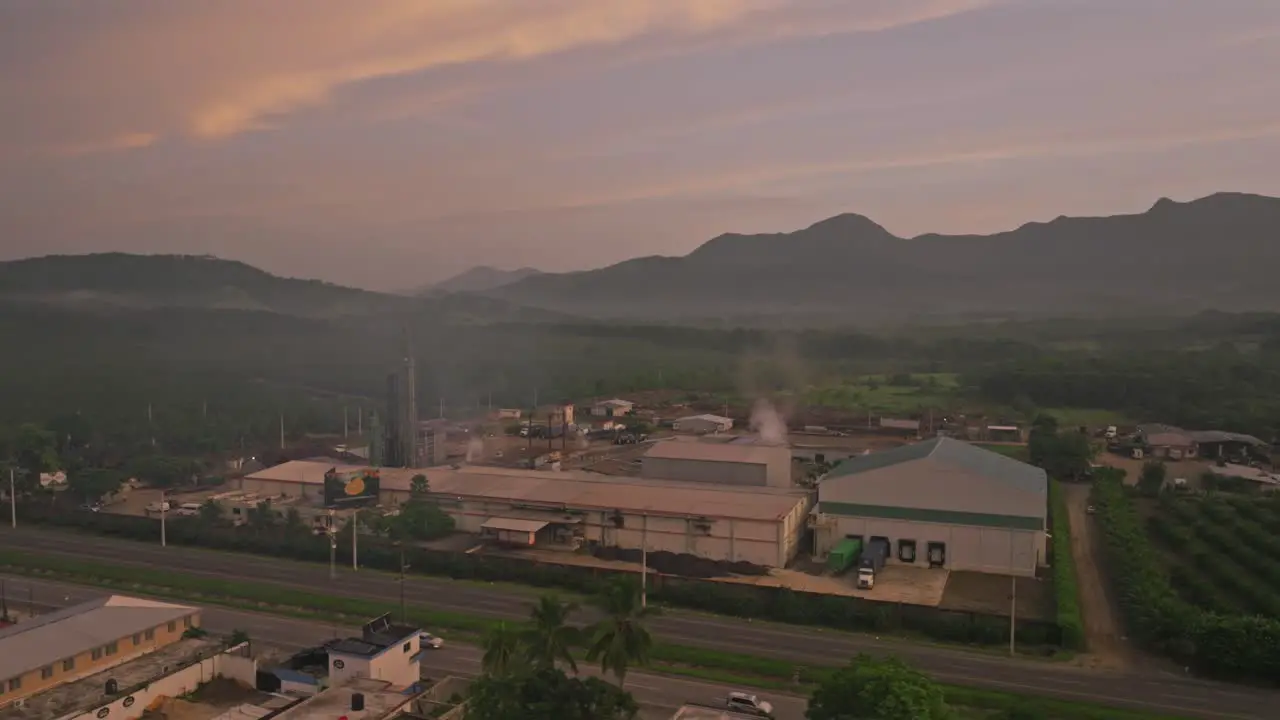 Aerial view pf traffic pm highway and fumes of factory rising into sky early in the morning Villa Altagracia Dominican Republic