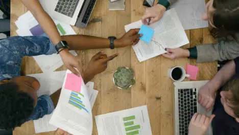 Overhead View Of Colleagues Working Together At Table