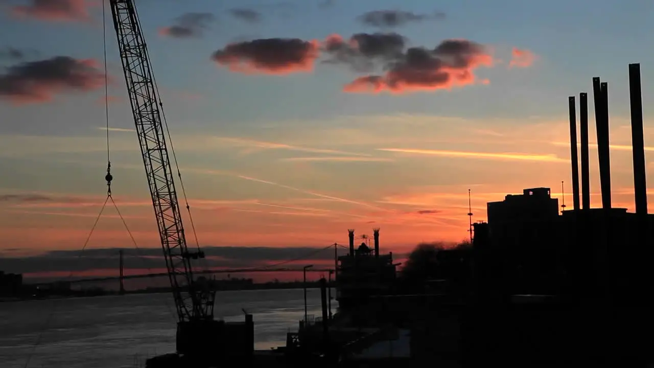 The sun sets as the clouds pass over a factory region near Detroit Michigan