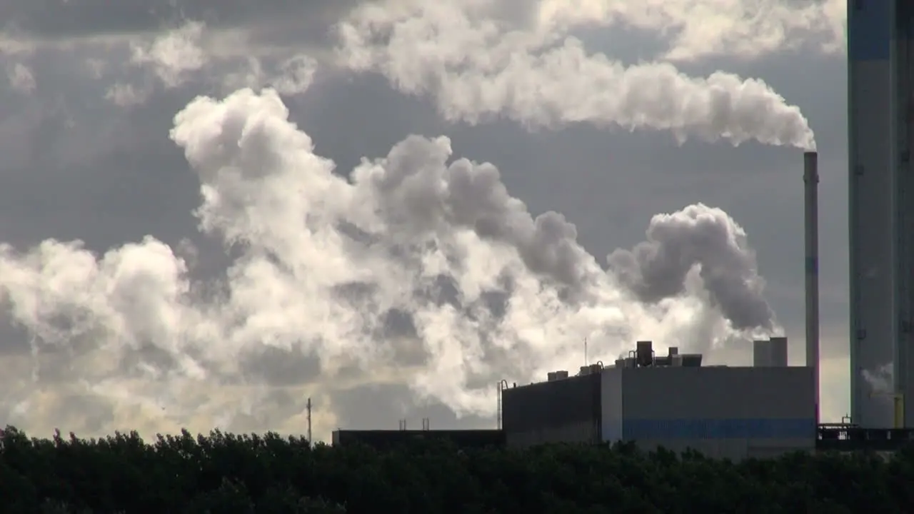 Netherlands Rotterdam two smokestacks spew into clouds zoom 2