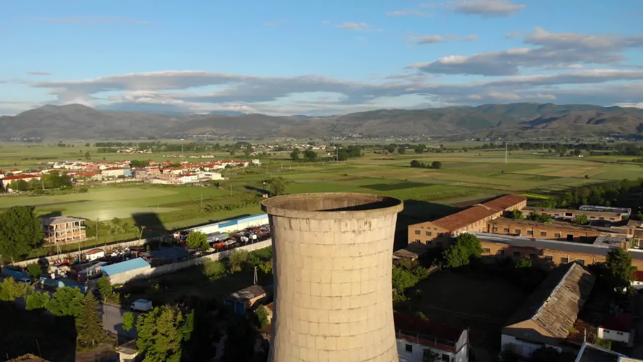 Industrial site of a complex with coal-fired plant station tall chimney tower in Albania