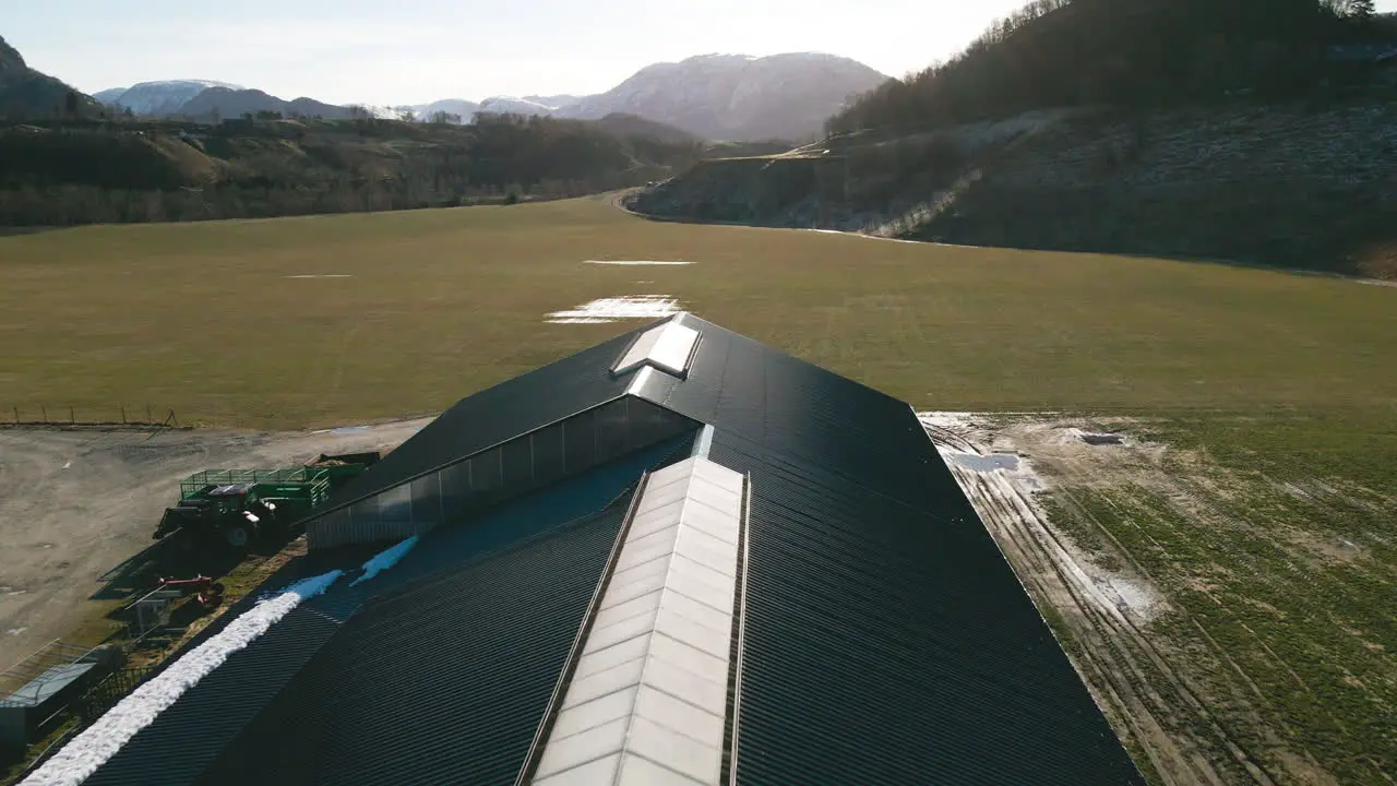 Flying Over Black Roof Of A Barn House In A Dairy Farm In Norway