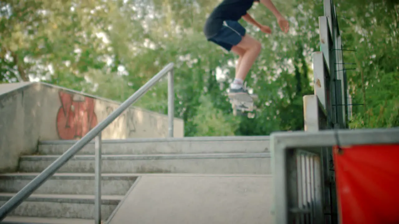 Skater Jumping Up Steps at Skatepark