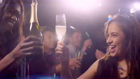 Young Woman Smiles and Drinks Champagne