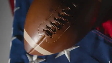 Close Up Studio Shot Of American Football On Stars And Stripes Flag 9