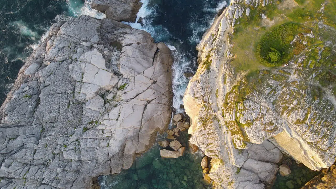 Zoom In Of Sea Waves Breaking On Rocky Coastline