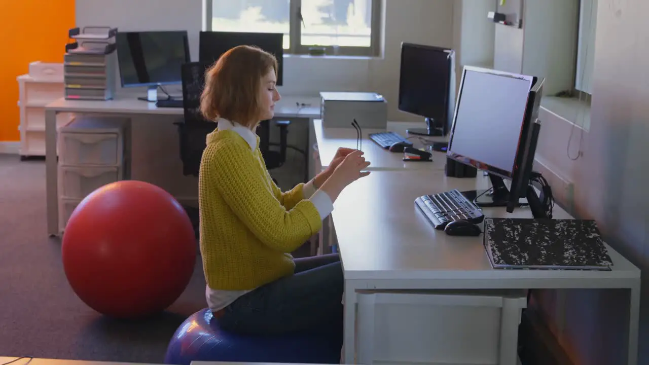 Young caucasian female executive meditating at desk in modern office 4k