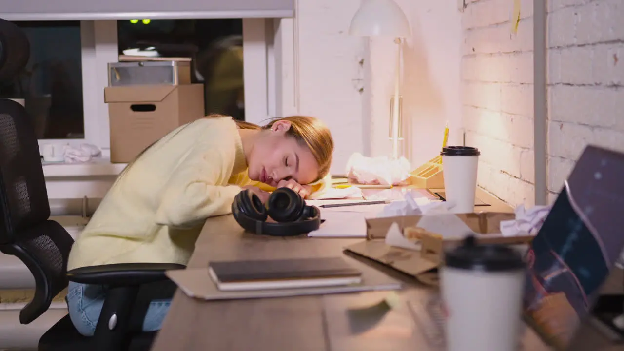 Tired Young Woman Taking Break To Rest And Having Nap At Workplace