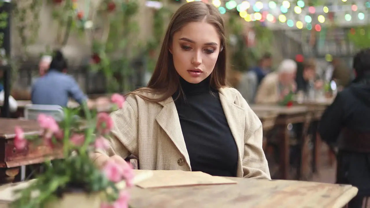 Smiling girl investigating menu in a coffee