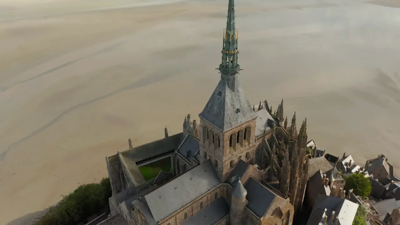 Mont Saint Michel Castle Top big Cathedral build in Ocean in France Aerial tilt down