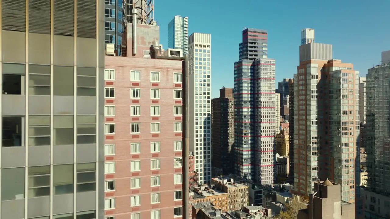 Slide and pan footage of high rise apartment buildings in midtown illuminated by bright sun Manhattan New York City USA