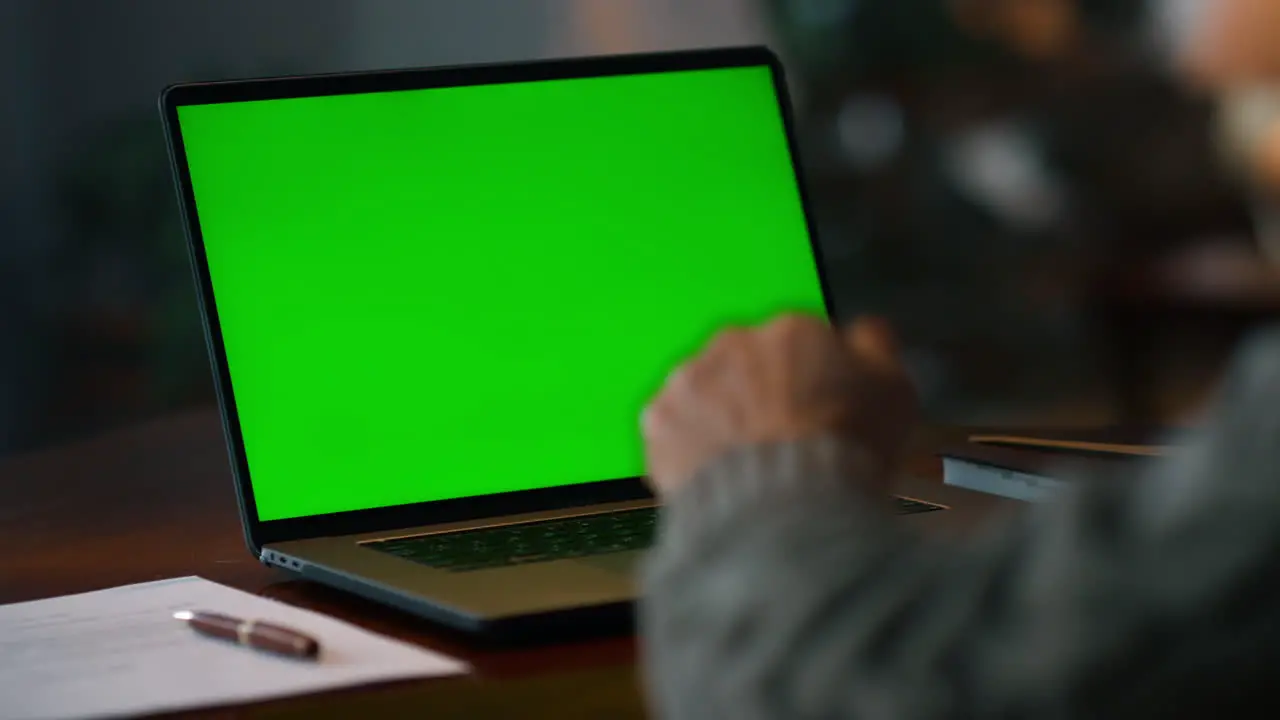 Chroma key computer closeup Old man having video call at green screen laptop