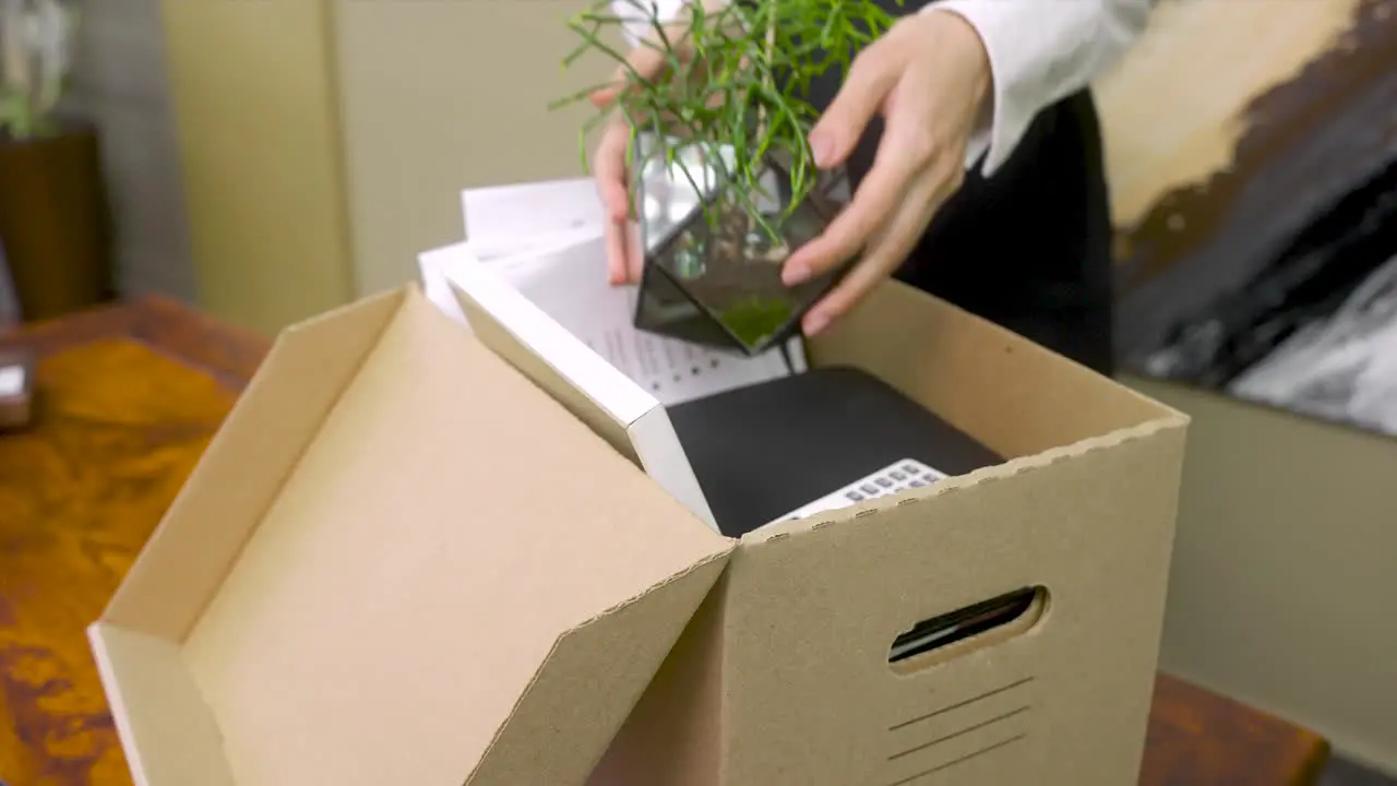 Close Up Of An Unrecognizable Female Employee Packing Office Stuff After Resignation