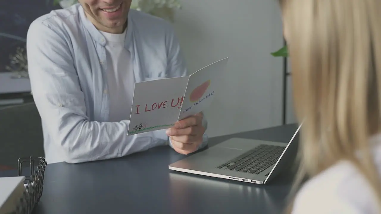 Dad Open A Greeting Card Of Her Little Daughter