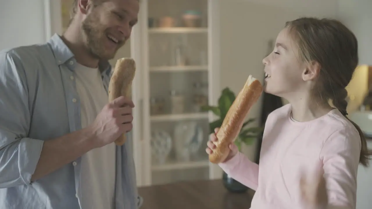 Man And Daughter Sing Dance And Play With Food At Home