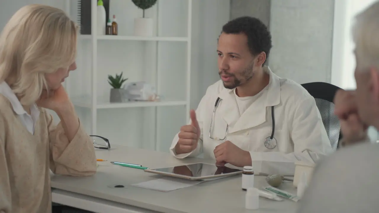 A Young Black Doctor In A Medical Consultation With A Ederly Couple 2