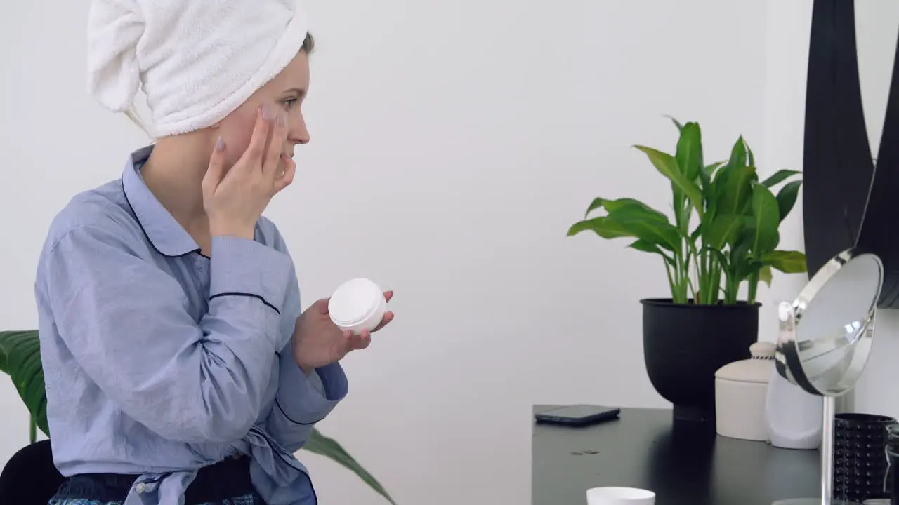 Young Woman Applying Moisturizer