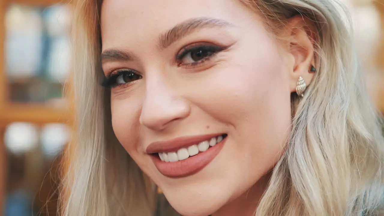 Portrait Of Pretty Young Blonde Woman In Makeup With Lipstick Looking At Camera