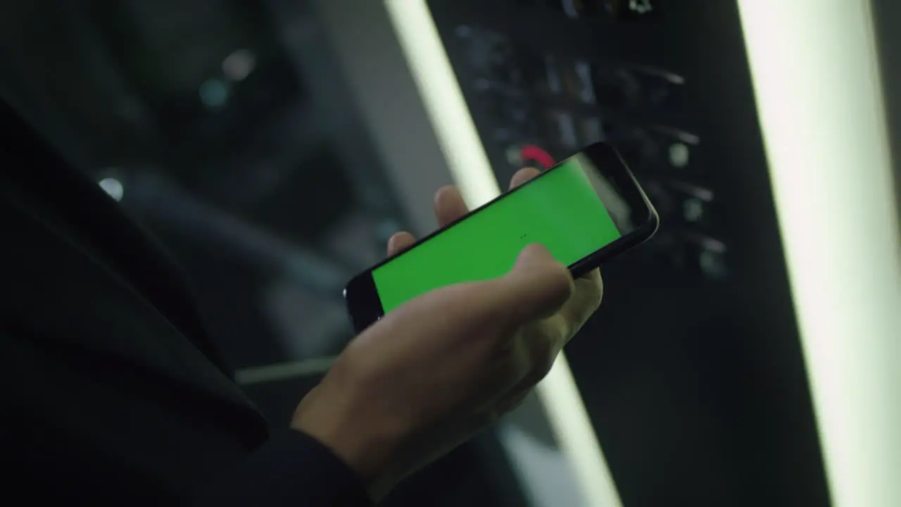 Man touching mobile smart phone with chroma key green screen