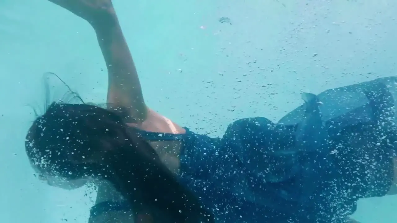 Beautiful woman swimming underwater