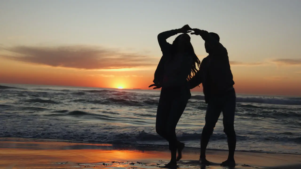 Sunset dancing and couple on a beach for vacation