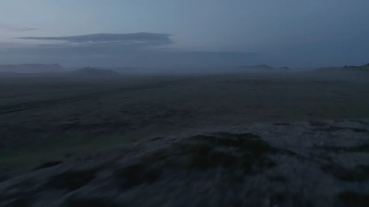 Aerial view or rural Iceland landscape covered with fog Car stopped in wilderness of icelandic countryside and tourist enjoying misty sunset of Iceland highlands