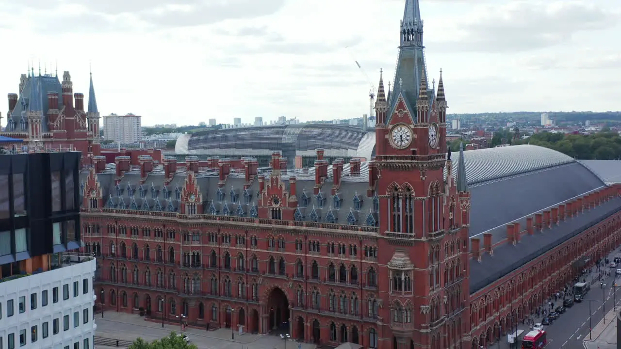 Descending aerial footage of majestic red brick historic building of St Pancras train station and hotel London UK