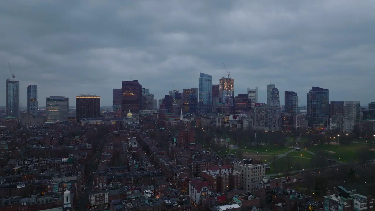 Cinematic footage of cityscape at dusk Residential urban borough public park and downtown skyscrapers in background Boston USA