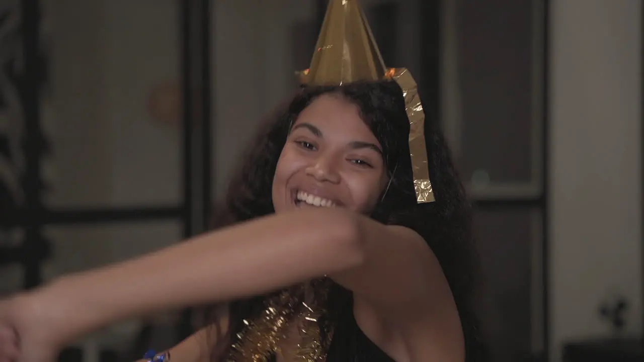 Portrait Of A Beautiful Black Woman Making Funny Faces Dancing Throwing Confetti At New Year's Eve Party