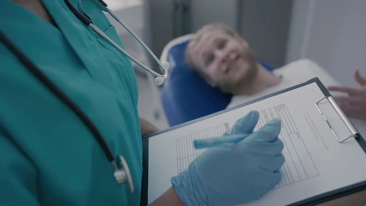 Detail Of An Empty Medical Report In The Hands Of An Unrecognizable Doctor