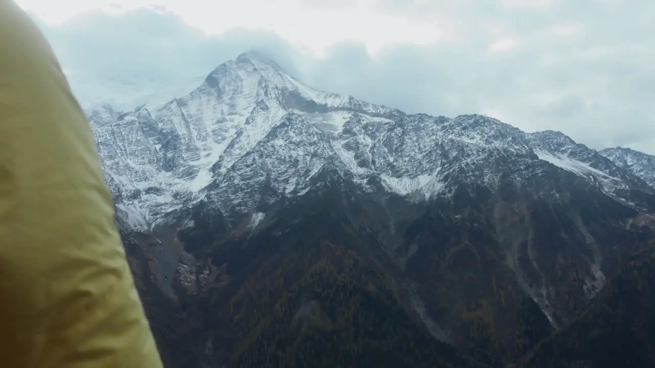 Hiker in Mountains Stretching Arms