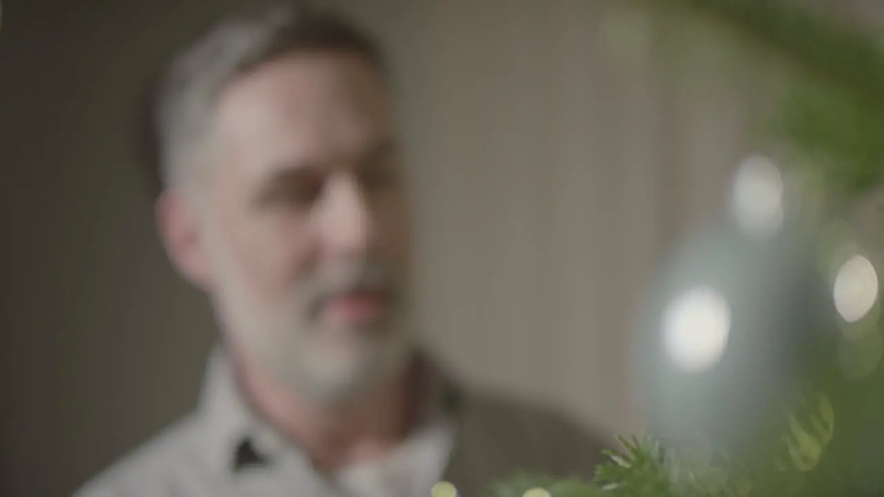 Pull Focus from Christmas Tree to Man Smiling