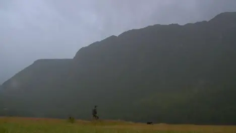 Father and Son Walking in Rain