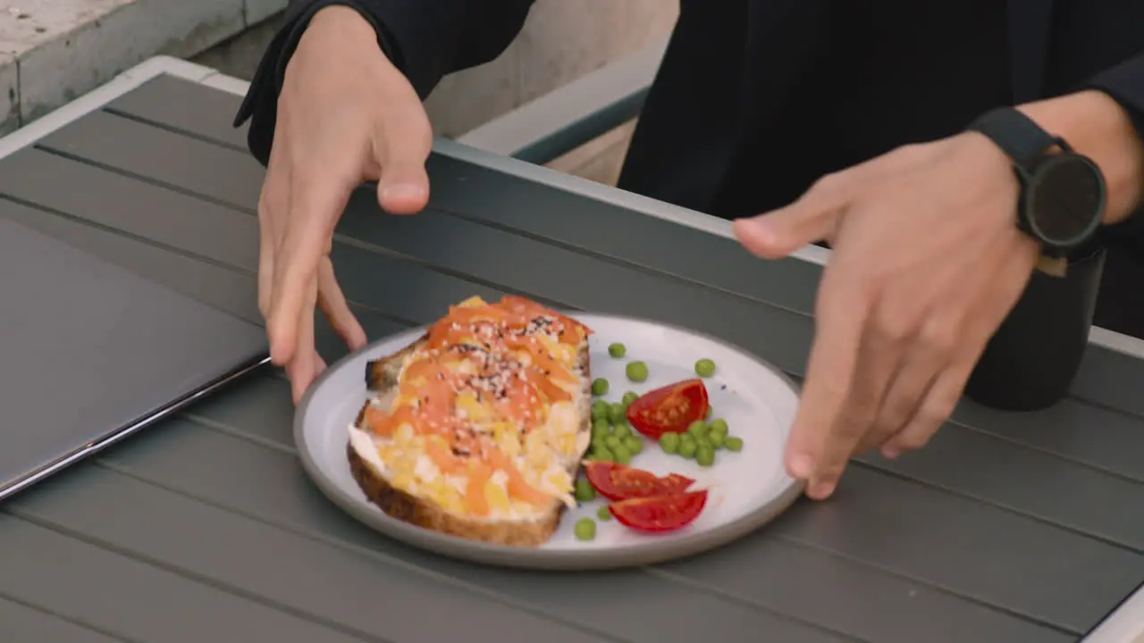 Close Up Of An Unrecognizable Businessman Closing His Laptop Computer And Being Ready To Have Lunch In A Coffee Shop