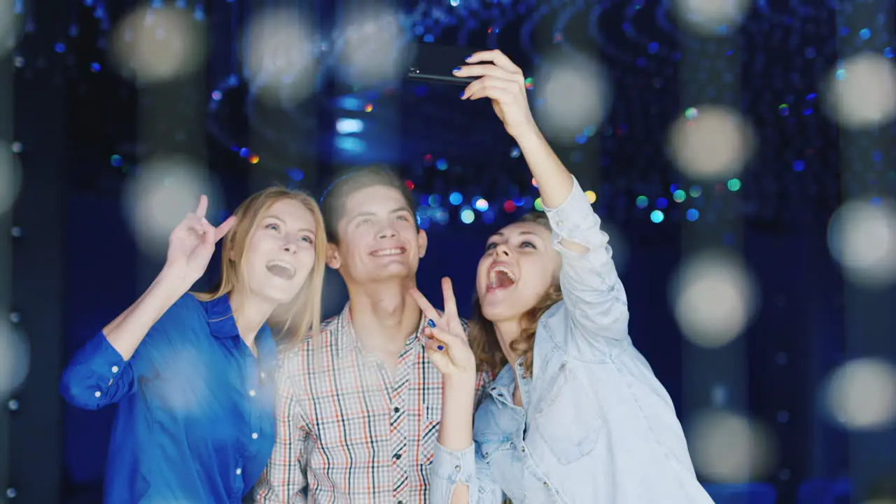 Young People Have A Good Time At A Party Use A Smartphone 1